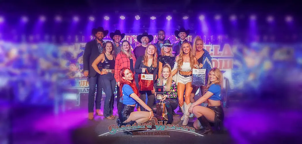 group-gathered-on-stage-under-purple-lighting-at-a-texas-paint-horse-club-event