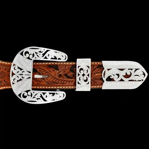 A custom western three piece belt buckle set featuring silver filigrane 