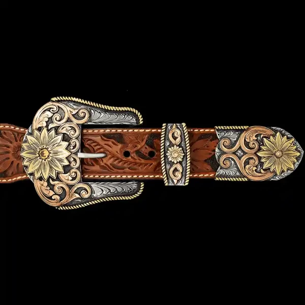 A custom western three piece belt buckle set featuring golden sunflower figures and copper scrollwork 