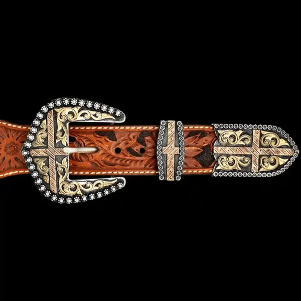 A custom western three piece belt buckle set featuring copper crosses and golden bronze scrollwork 