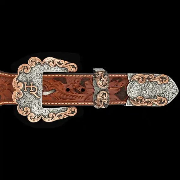 A custom western three piece betl buckle set featuring a personalized ranch brand and copper scrollwork edge 