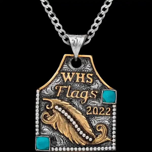 A cow tag necklace featuring custom bronze lettering, feather figure and turquoise stone 