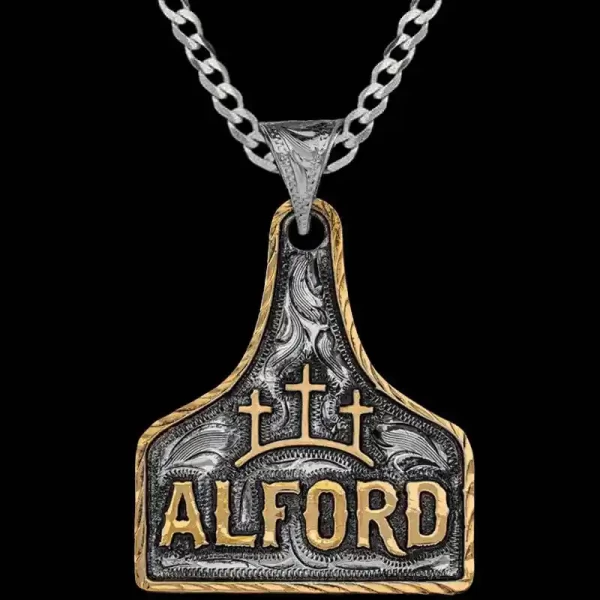 A silver hand engraved cow tag necklace featuring custom bronze lettering and ranch brand 