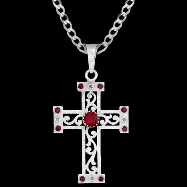 A custom silver cross pendant necklace for men and women, western-inspired design. featuring silver filigrane and red zirconia stones 