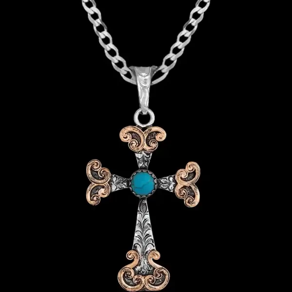 A custom silver cross pendant necklace for men and women, western-inspired design. featuring bronze scrolls and turquoise stone