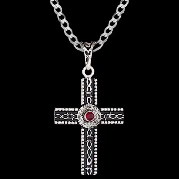A custom silver cross pendant necklace for men and women, western-inspired design. featuring barbed wire details and red zirconia stone