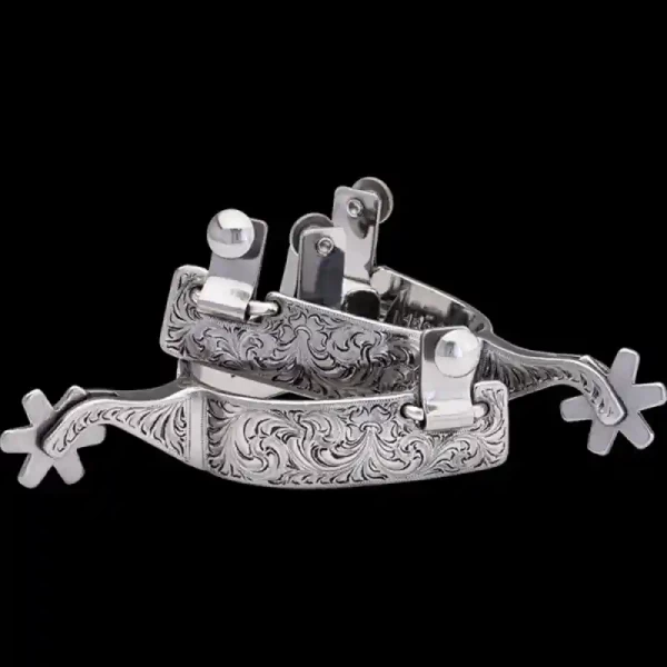 A custom pair of cowboot boot spurs with hand engraved details 