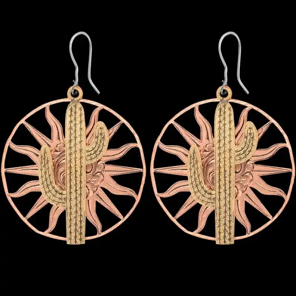 A pair of copper western earrings for women featuring cactus bronze figures on sun copper bases