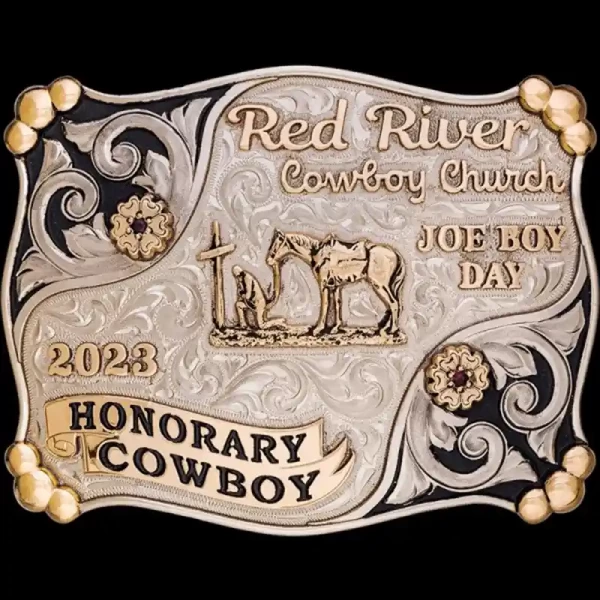 A custom western belt buckle for Red River Cowboy Church featuring a praying cowboy to a cross figure