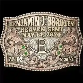 A custom newborn belt buckle with personalized name, birth date and ranch brand 