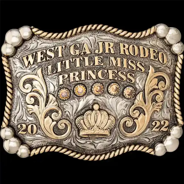 A custom rodeo queen belt buckle featuring a queen crown figure 