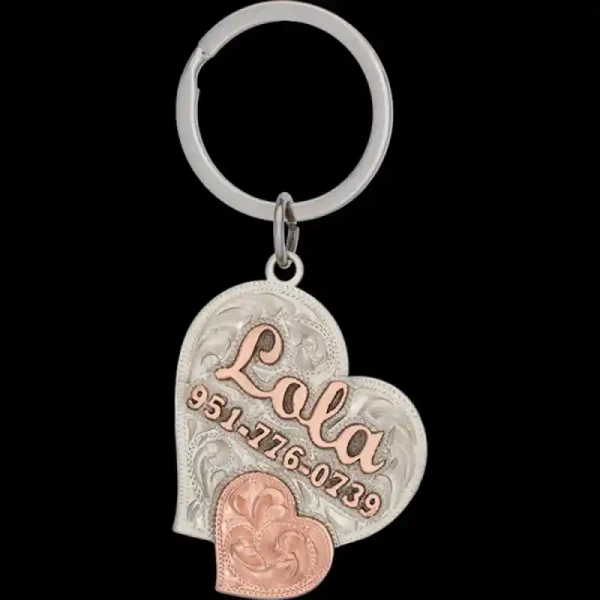 A  custom dog tag with personalized engraved copper lettering built on a heart-shaped silver base, featuring a copper heart figure, western designed