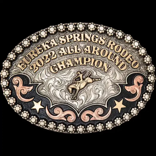 A custom oval rodeo belt buckle trophy for Eureka Springs Rodeo All Around Champion featuring a bronc rider figure 