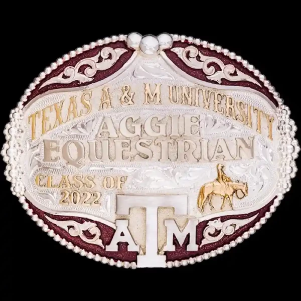 A custom oval graduation belt buckle for Texas A&amp;M University Equestrian Team featuring a cowgirl figure 