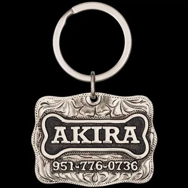 A custom dog tag with personalized engraved silver lettering, built on a silver base, featuring a bone figure, western designed 
