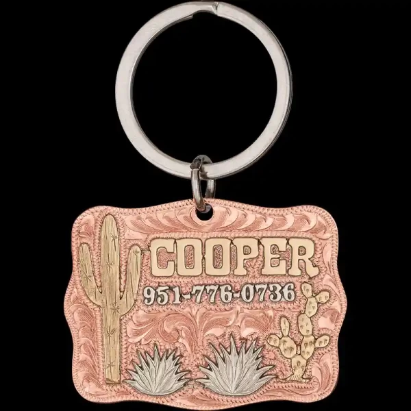 A custom dog tag with personalized engraved bronze lettering built on a copper base, featuring bronze cactus, western designed
