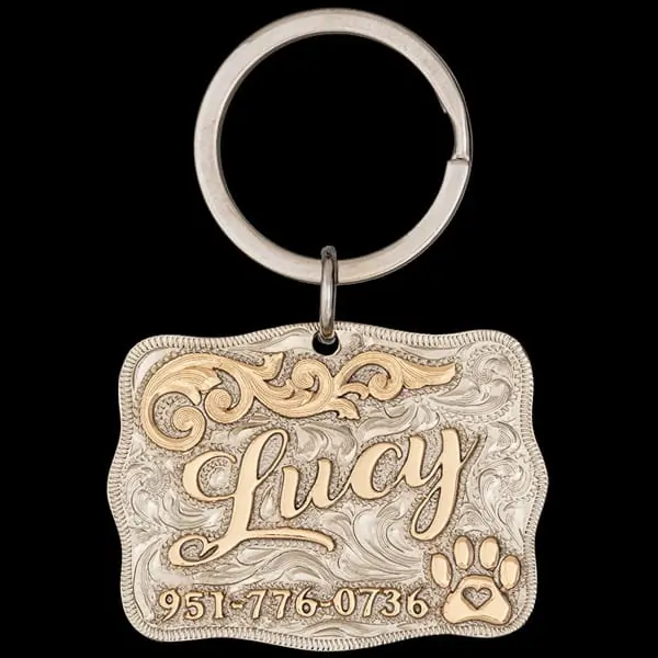 A custom dog tag with personalized engraved bronze lettering built on a german silver base, featuring a golden paw, western designed