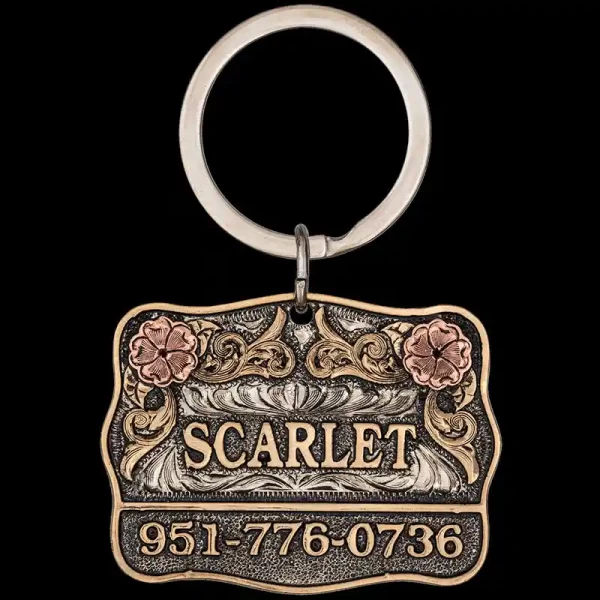 A custom dog tag with personalized engraved bronze lettering built on a matted silver base, featuring copper roses, western designed 