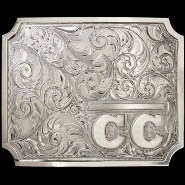 A custom silver square belt buckle built on a hand engraved base featuring a ranch brand logo