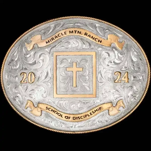 A custom oval silver western belt buckle featuring a cross figure