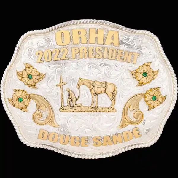 A custom silver plated western belt buckle featuring a praying cowboy figure 