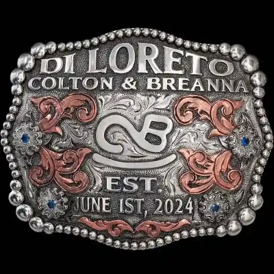 A custom silver belt buckle featuring a ranch brand logo
