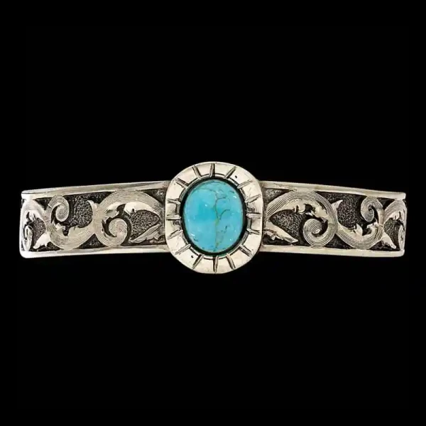 A women's cuff bracelet featuring a large turquoise stone