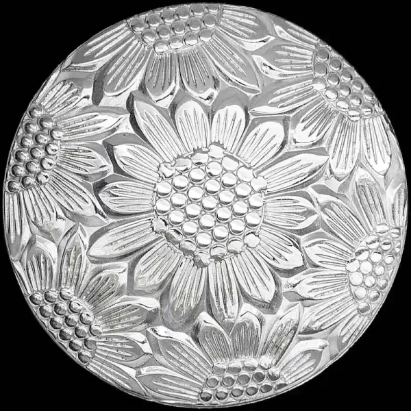 A hand engraved custom silver concho in natural finish featuring a sunflower pattern