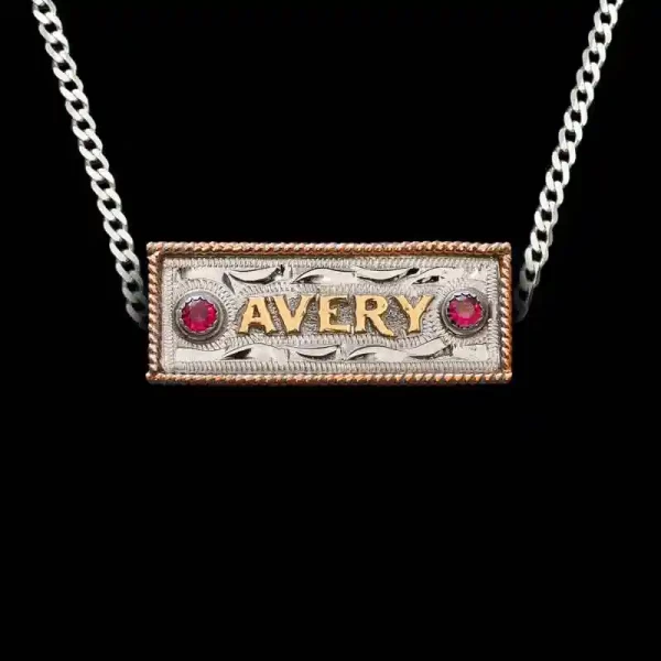 A custom name plate pendant necklace featuring personalized bronze lettering, with a sterling silver chain