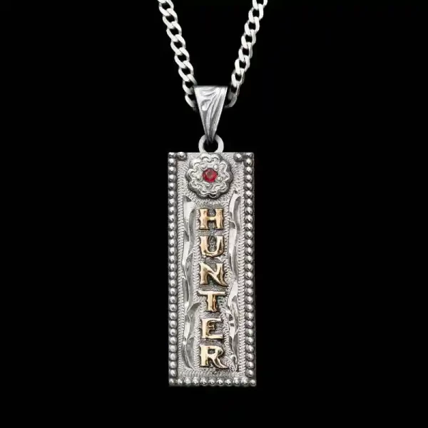 A custom name tag pendant necklace featuring a rectangular shape and golden lettering, with a sterling silver chain