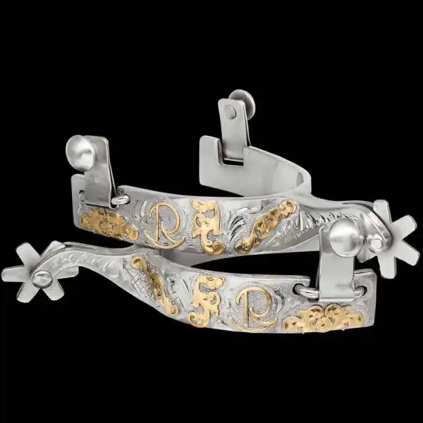 A custom pair of cowboy boot spurs with handmade details featuring personalized lettering and a bronze ranch brand 