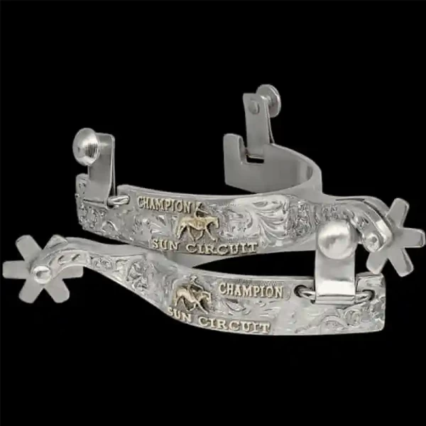 A custom pair of cowboy boot spurs with handmade details featuring personalized lettering and a cowgirl figure 