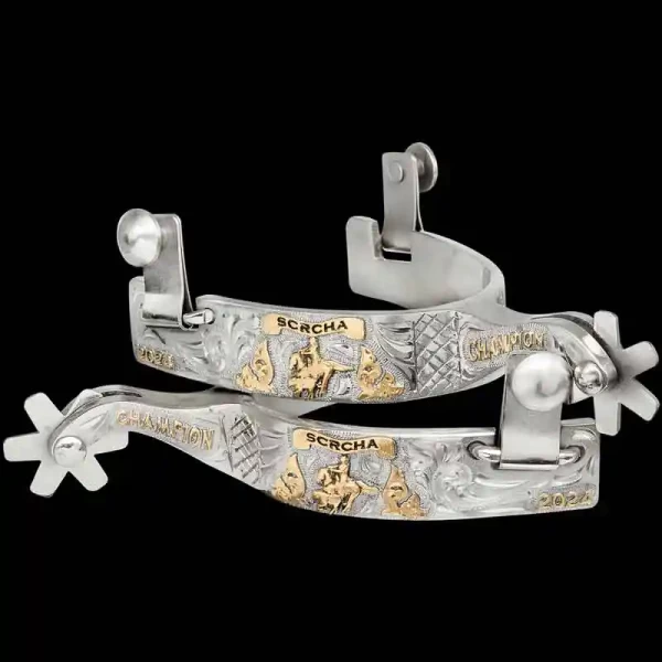 A custom pair of cowboy boot spurs with handmade details featuring personalized lettering and a cowgirl figure 