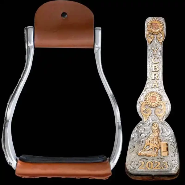 A custom set of stirrups built on aluminum featuring personalized lettering and a barrel racer bronze figure 