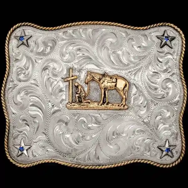 A custom western belt buckle featuring a praying cowgirl figure 