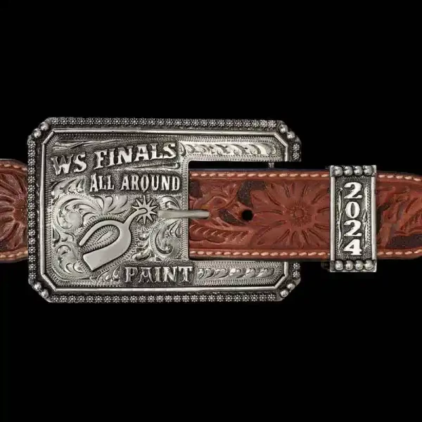 A custom western three piece belt buckle set featuring a square buckle with personalized lettering and a spur figure 