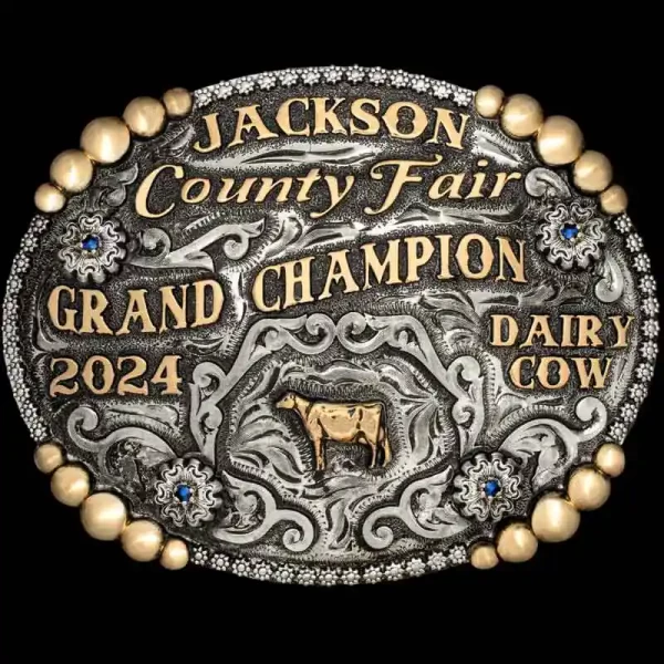 A custom oval farming belt buckle trophy for Jackson County Fair Champion featuring a cow figure