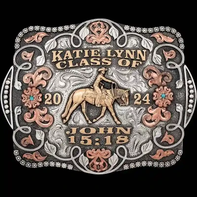 A custom women's graduation belt buckle featuring a cowgirl figure and bible verse 