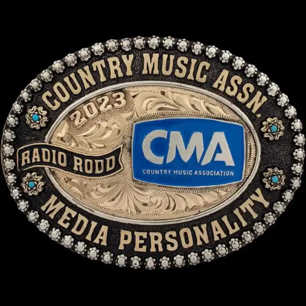 A custom oval personalized belt buckle for Country Music Association Radio Rodd featuring its custom logo 