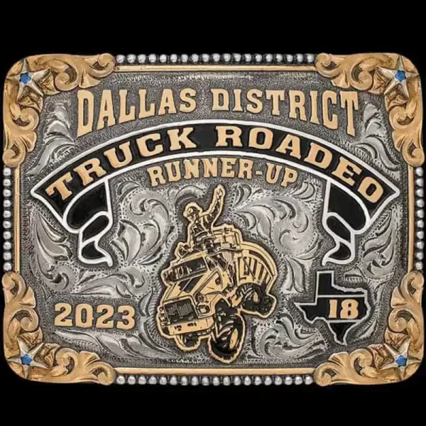 A custom trucker belt buckle for Dallas District Truck Rodeo featuring a trucker custom logo and a Texas State figure 