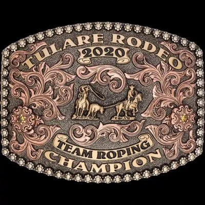 A custom award rodeo belt buckle for Tulare Rodeo Team Roping Champion featuring a team roper figure 