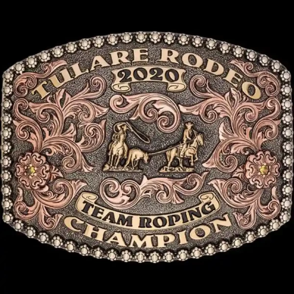 A custom award rodeo belt buckle for Tulare Rodeo Team Roping Champion featuring a team roper figure 