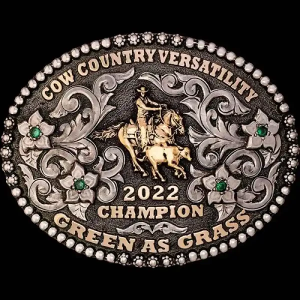 A custom oval rodeo belt buckle trophy for Cow County Versatility Champion featuring a calf roping cowboy figure