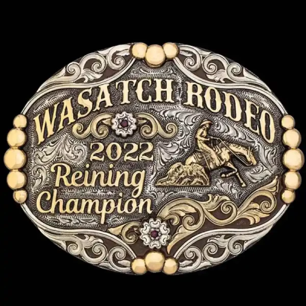 A custom oval rodeo belt buckle for Wasatch Rodeo Reining Champion featuring a reining cowboy figure