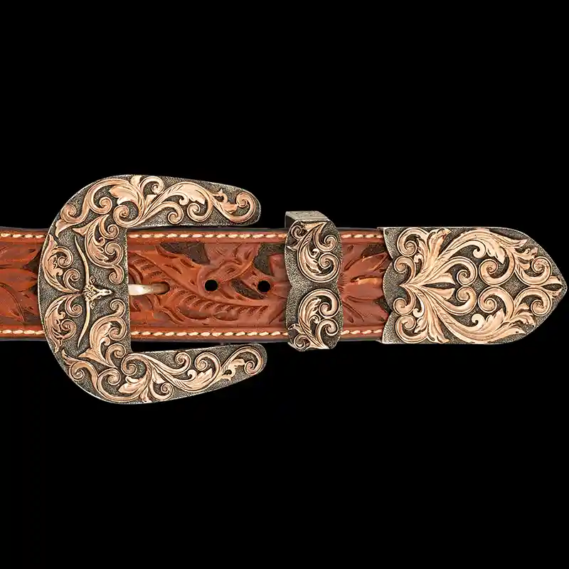 A custom western three piece belt buckle set featuring a longhorn figure 