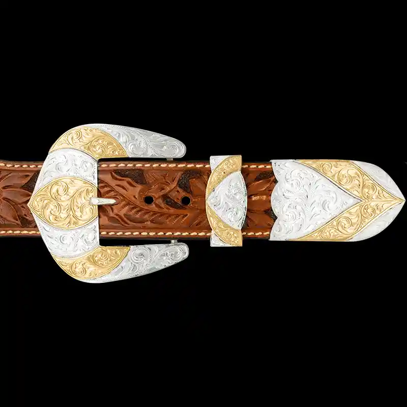 A custom western three piece betl buckle set featuring a silver plated base and golden bronze accents