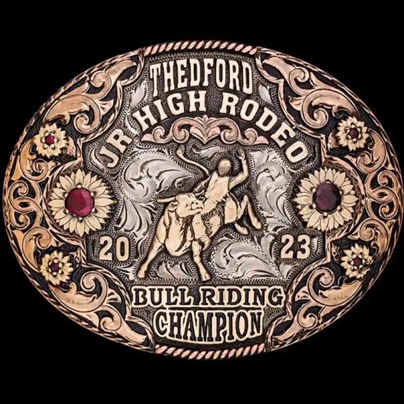 A custom oval rodeo belt buckle trophy for Thedford Junior High Rodeo Bull Riding Champion featuring a bull rider figure