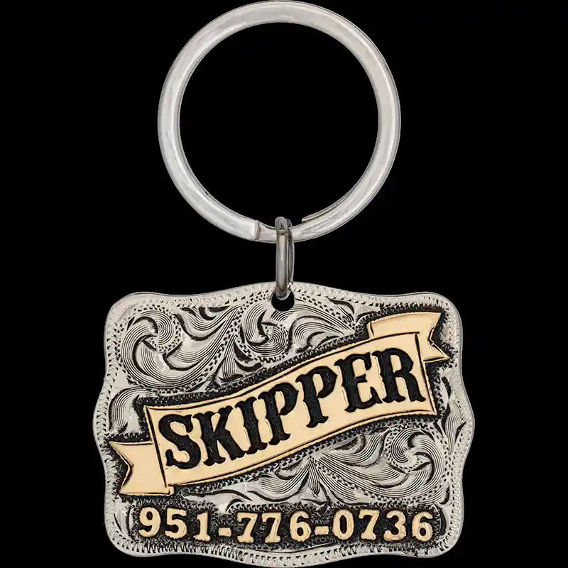 A custom dog tag with personalized engraved bronze lettering built on a square antiqued silver base, western designed 