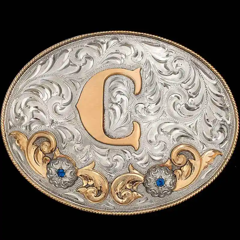 A custom oval initials belt buckle with silver hand engraved base