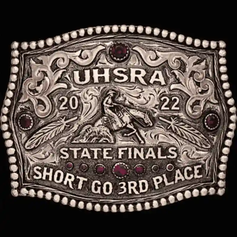 A custom women's rodeo belt buckle award for UHSRA State Finals featuring a reining cowgirl figure 